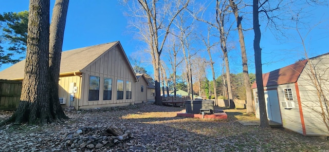 view of side of home with an outdoor fire pit