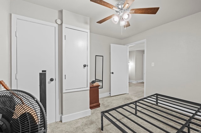 bedroom featuring light carpet, a closet, and ceiling fan