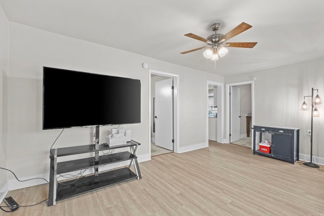 living room featuring ceiling fan and light hardwood / wood-style floors