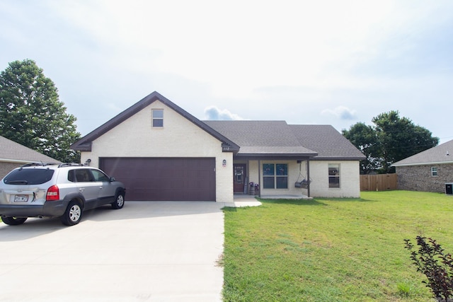 view of front facade featuring a front yard and a garage