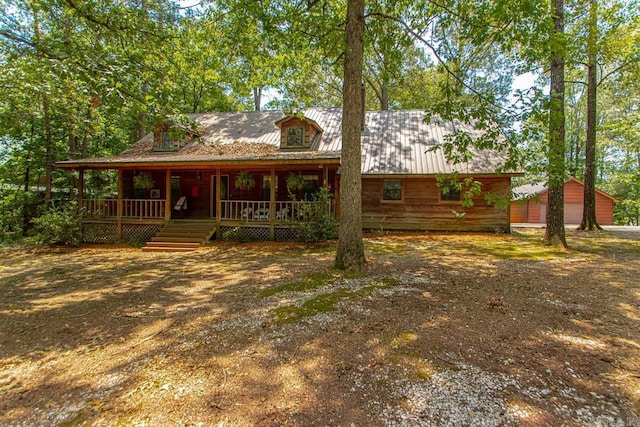 exterior space with a porch, an outbuilding, and a garage