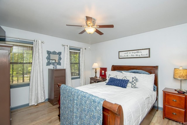 bedroom with ceiling fan and light hardwood / wood-style floors