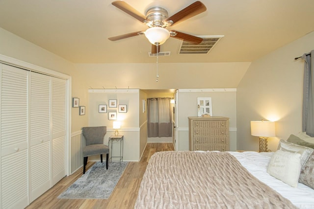 bedroom featuring ceiling fan, a closet, vaulted ceiling, and light hardwood / wood-style flooring