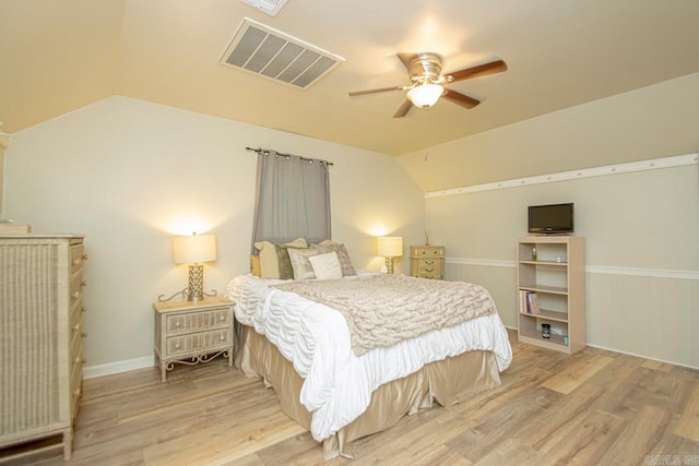 bedroom featuring ceiling fan, light hardwood / wood-style flooring, and vaulted ceiling