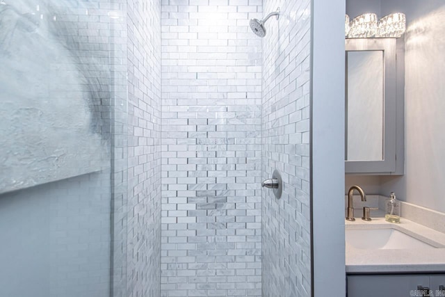 bathroom with vanity and tiled shower