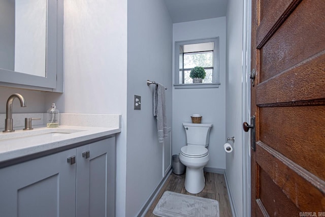 bathroom featuring hardwood / wood-style floors, vanity, and toilet