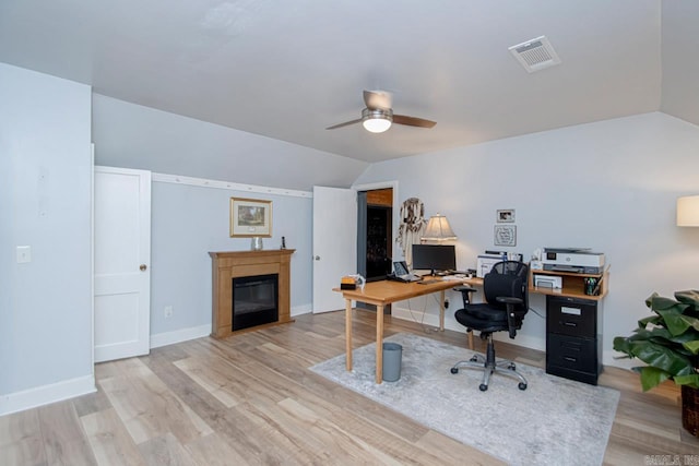 home office featuring ceiling fan, lofted ceiling, and light wood-type flooring