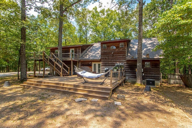 rear view of house featuring a wooden deck and cooling unit