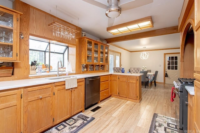 kitchen with high end range, kitchen peninsula, sink, black dishwasher, and light hardwood / wood-style floors