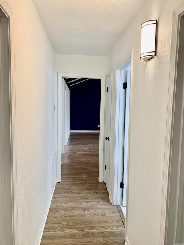 corridor featuring hardwood / wood-style floors