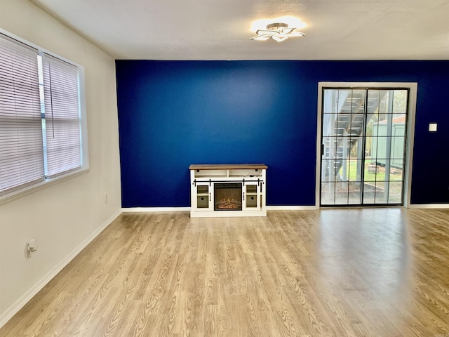 unfurnished living room with light hardwood / wood-style flooring