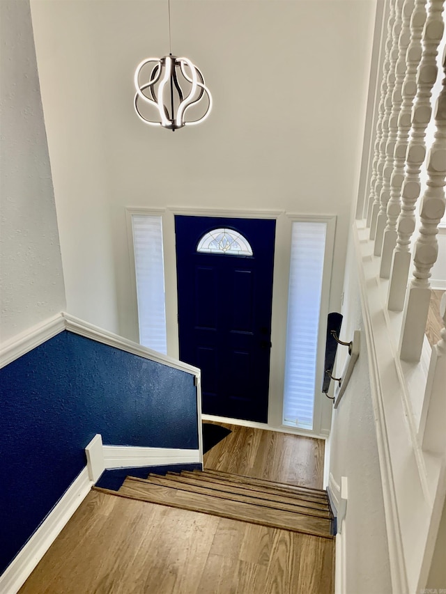 foyer entrance featuring a chandelier and hardwood / wood-style flooring