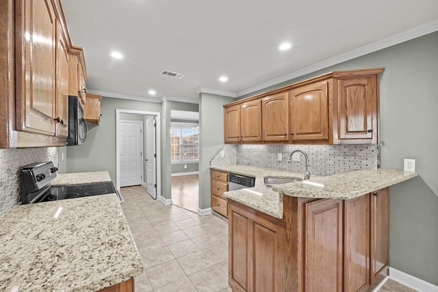 kitchen with light stone counters, sink, stainless steel appliances, and ornamental molding