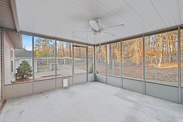 unfurnished sunroom with ceiling fan