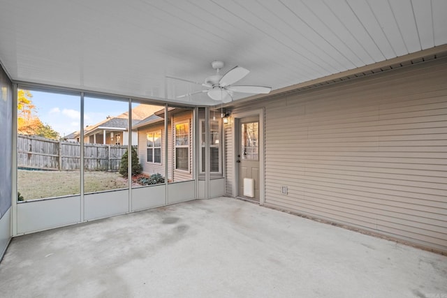 unfurnished sunroom with ceiling fan