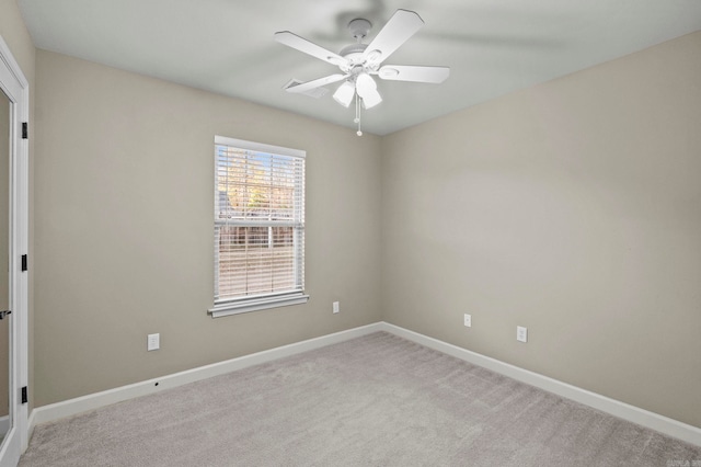 carpeted spare room featuring ceiling fan