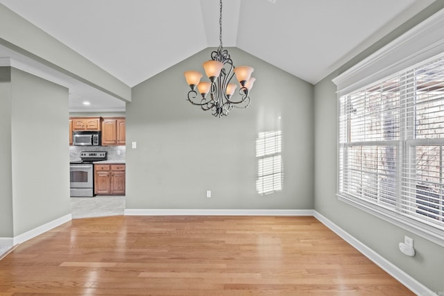 unfurnished dining area with light wood-type flooring, lofted ceiling, and a notable chandelier