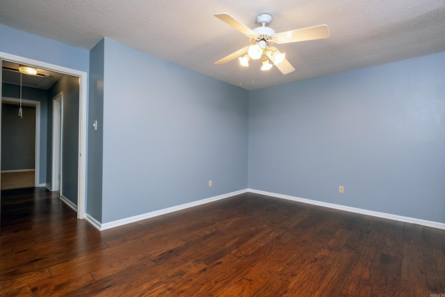 spare room featuring a textured ceiling, ceiling fan, and dark hardwood / wood-style floors