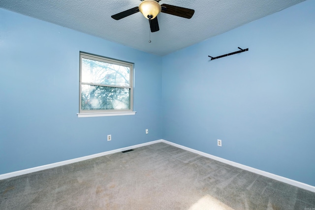 carpeted empty room featuring a textured ceiling and ceiling fan