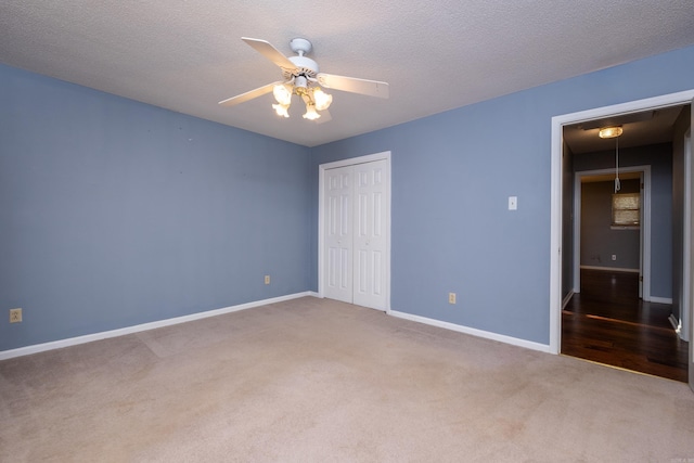 unfurnished bedroom with ceiling fan, a closet, carpet, and a textured ceiling