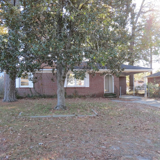 obstructed view of property with a carport