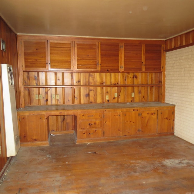 interior space with wooden walls and brick wall