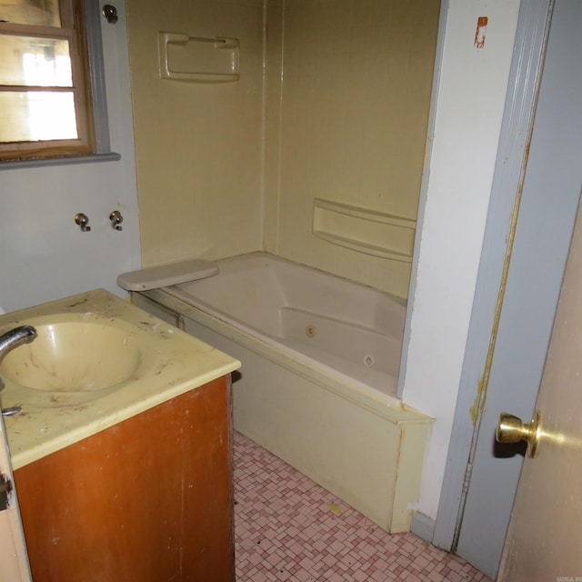 bathroom featuring vanity and a bath