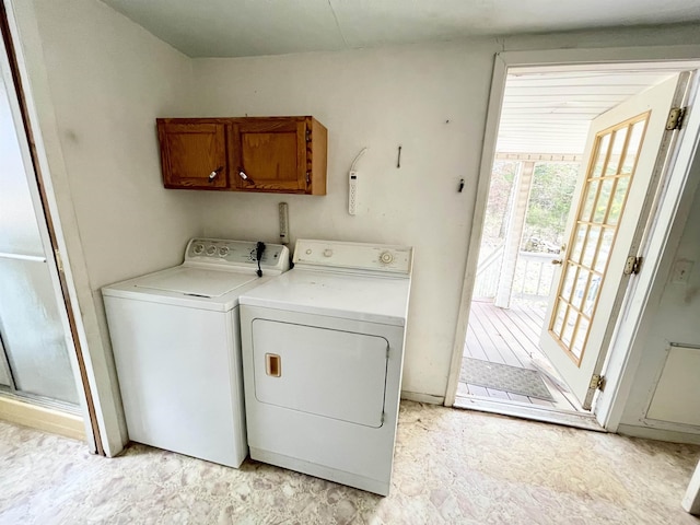 laundry room featuring separate washer and dryer and cabinets