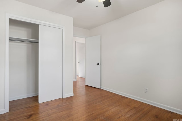 unfurnished bedroom with hardwood / wood-style floors, ceiling fan, and a closet