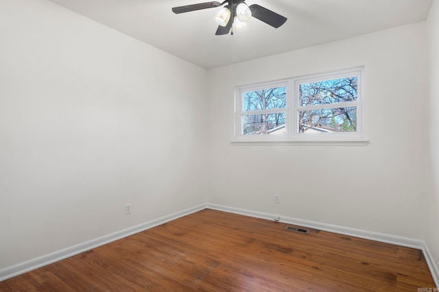 spare room with hardwood / wood-style flooring and ceiling fan