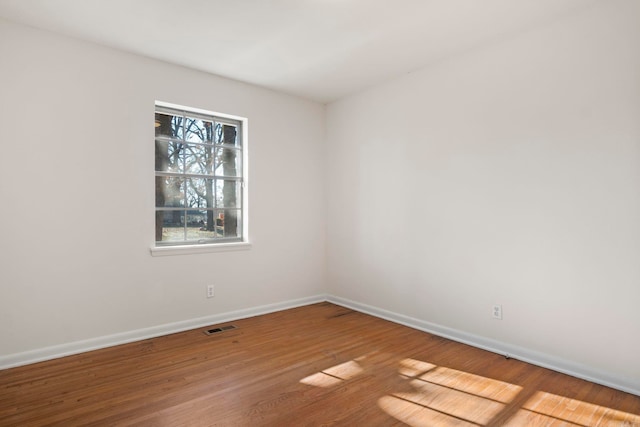 empty room with wood-type flooring