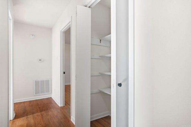 corridor featuring hardwood / wood-style floors