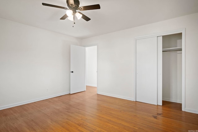 unfurnished bedroom with a closet, ceiling fan, and hardwood / wood-style floors