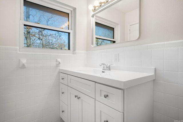 bathroom with vanity and tile walls