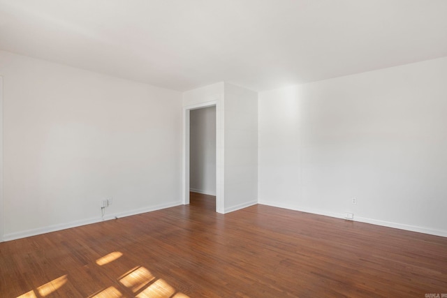 spare room with dark hardwood / wood-style flooring