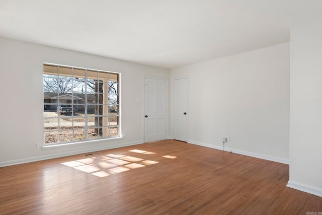 unfurnished room with hardwood / wood-style flooring