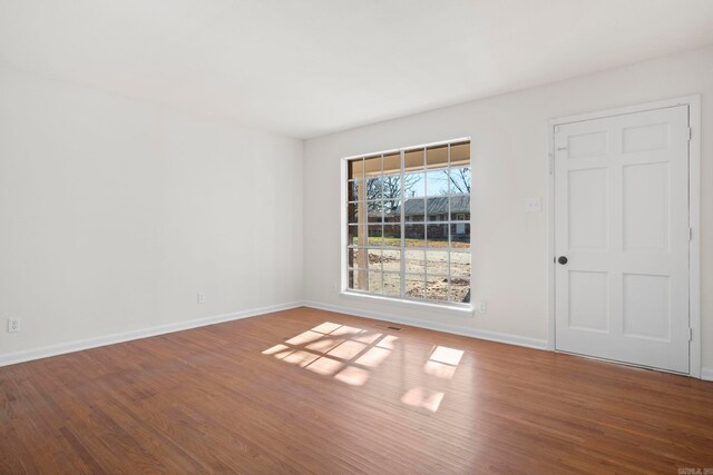 spare room with hardwood / wood-style floors