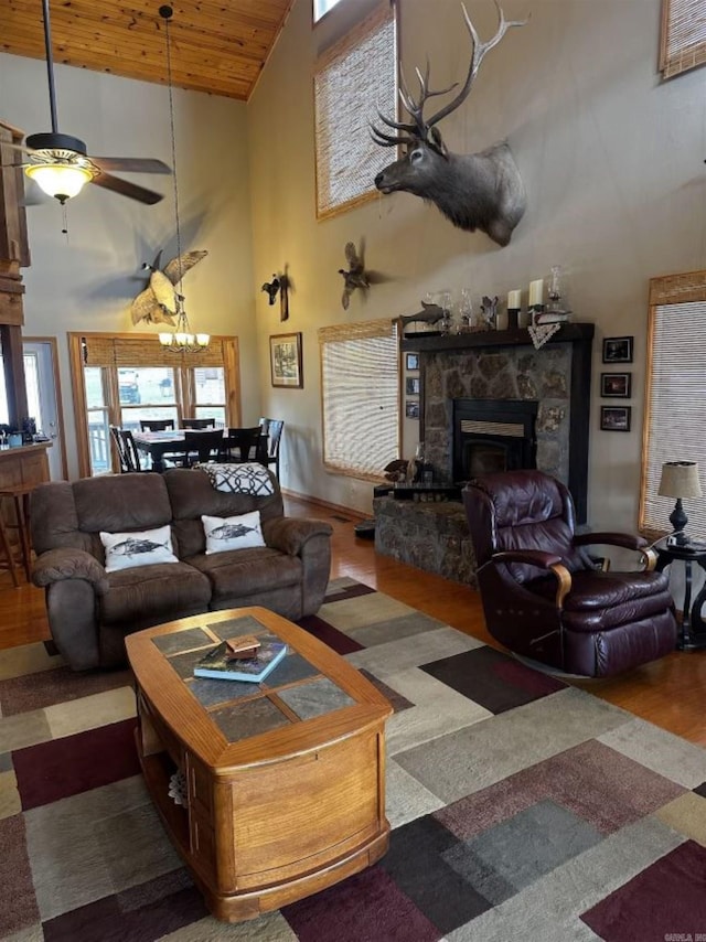 living room with a fireplace, hardwood / wood-style flooring, high vaulted ceiling, and wooden ceiling