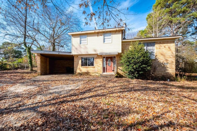 tri-level home featuring a carport