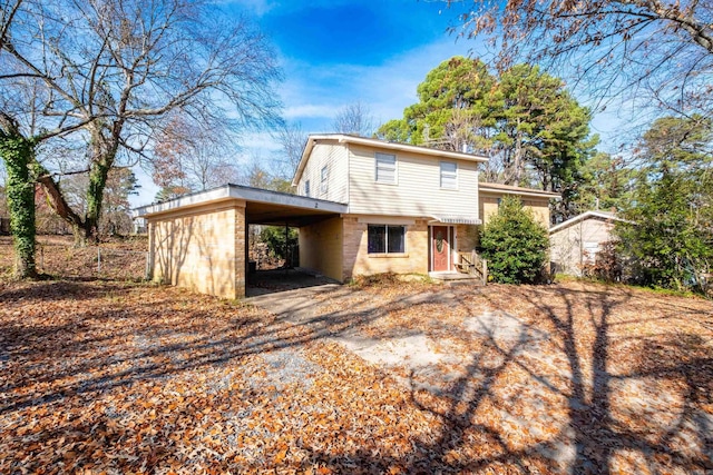 back of property featuring a carport