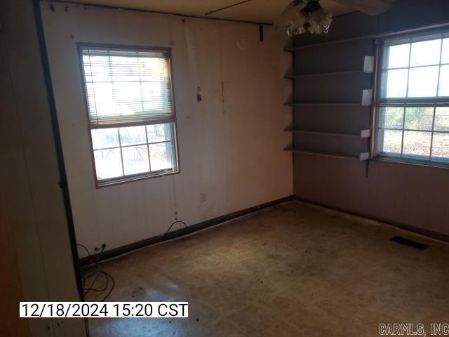 unfurnished room featuring concrete flooring