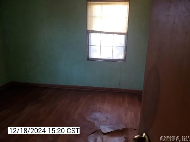 unfurnished room featuring hardwood / wood-style flooring