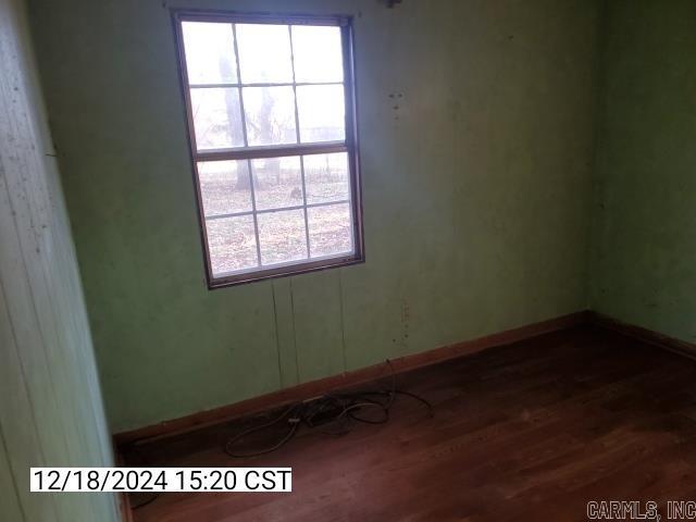 unfurnished room featuring dark hardwood / wood-style flooring