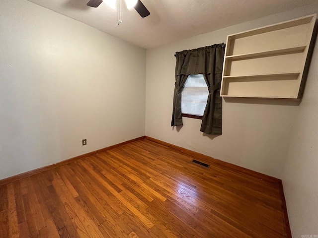 spare room featuring hardwood / wood-style floors and ceiling fan