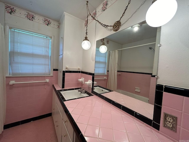 bathroom with a shower with shower curtain, vanity, tile patterned flooring, and tile walls