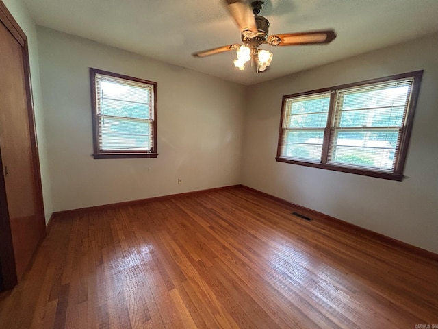 unfurnished room with wood-type flooring and ceiling fan