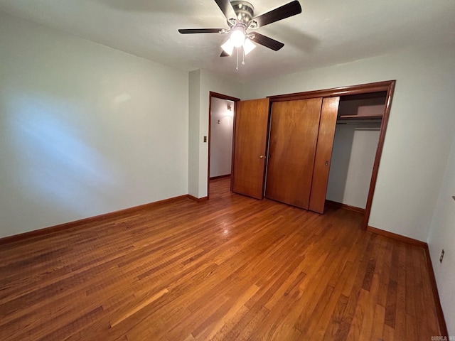 unfurnished bedroom with a closet, light hardwood / wood-style flooring, and ceiling fan