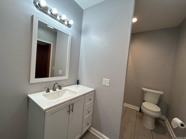 bathroom featuring tile patterned flooring, vanity, and toilet