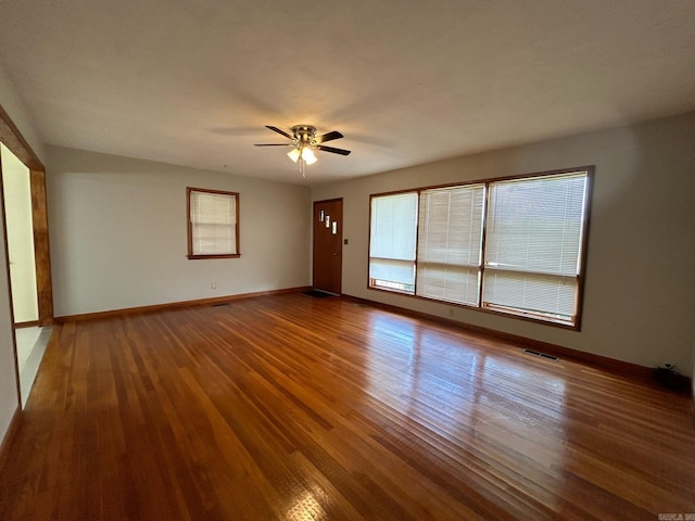 spare room with wood-type flooring and ceiling fan