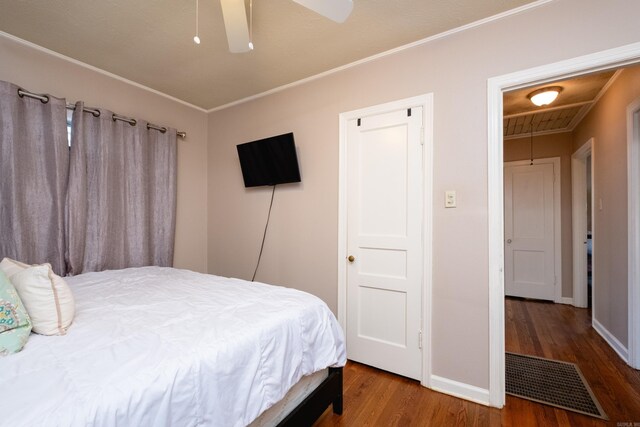 bedroom featuring a walk in closet, a closet, hardwood / wood-style flooring, and ceiling fan